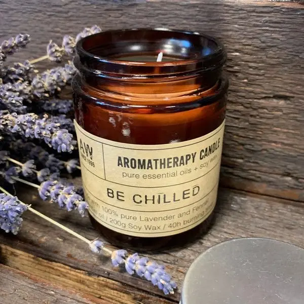 Soy wax aromatherapy candle in an amber glass jar with a kraft gift box