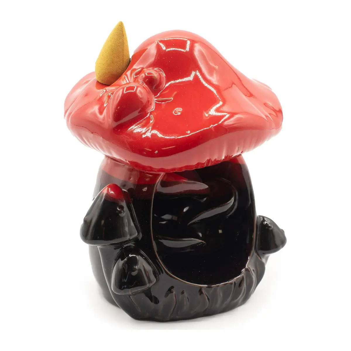 Glossy red ceramic mushroom backflow incense burner on a tree trunk base