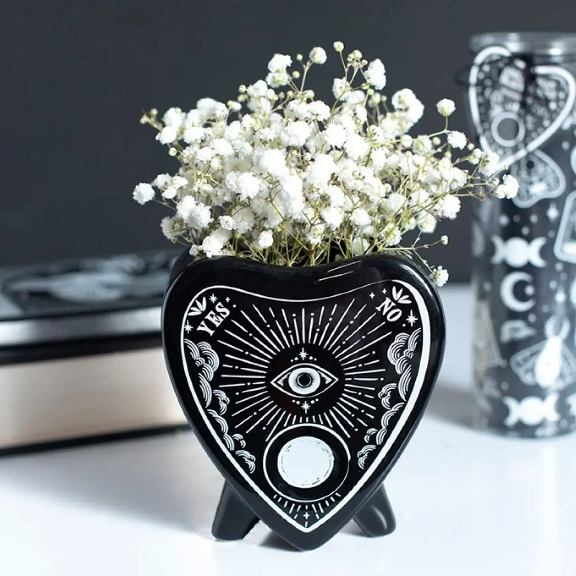 Black ceramic flower vase inspired by a talking board planchette