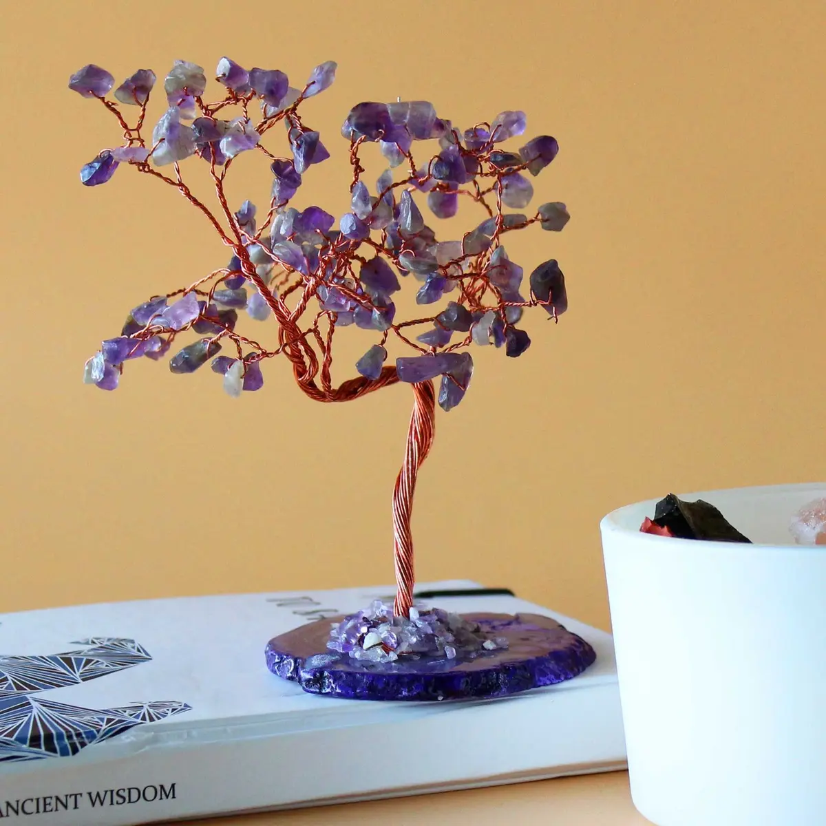 Amethyst gemstone tree with purple stones on a natural agate base
