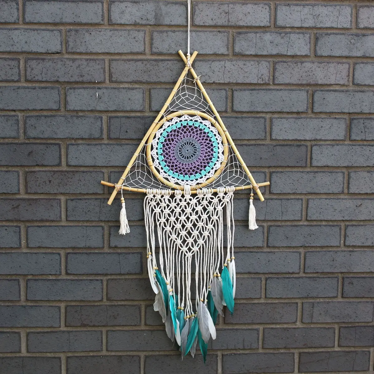 White and turquoise macrame pyramid dream catcher with feathers