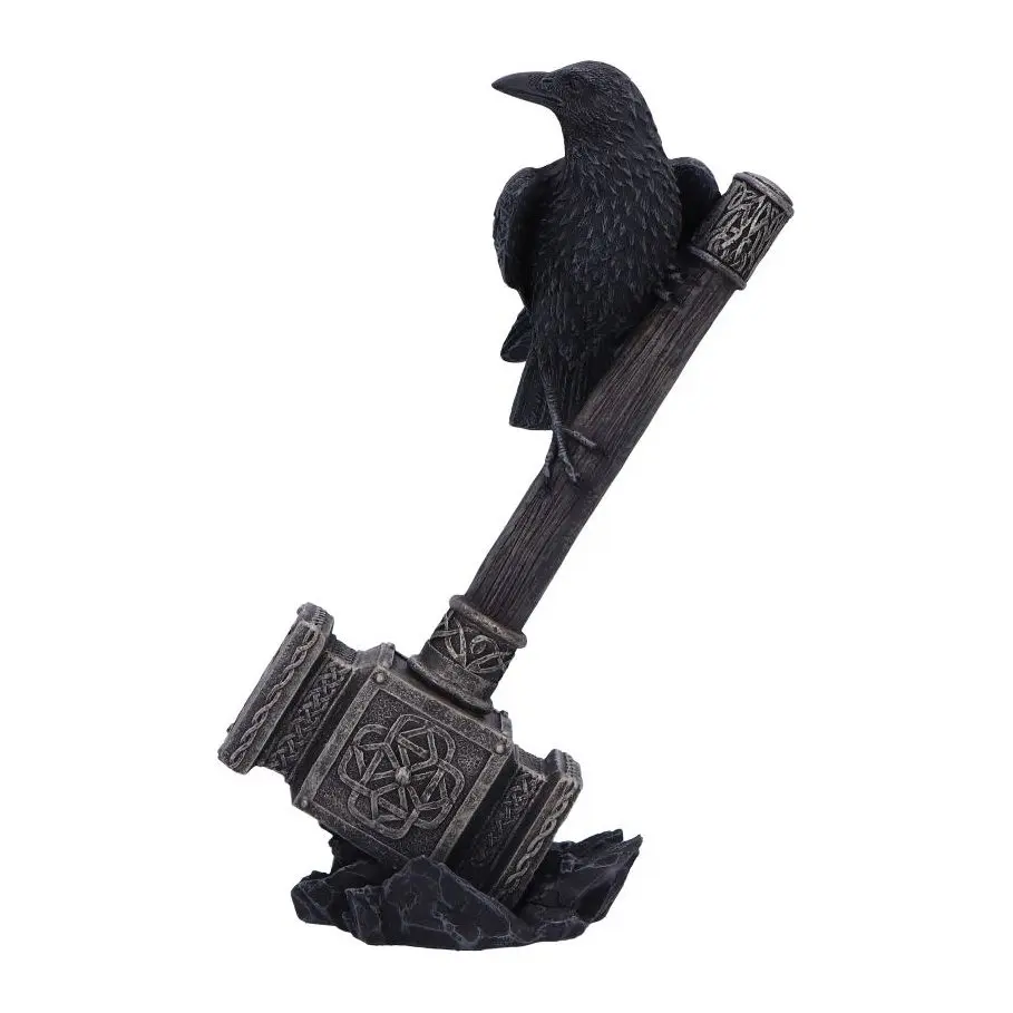 Black raven perched on Thor's hammer with a golden head on black rocks