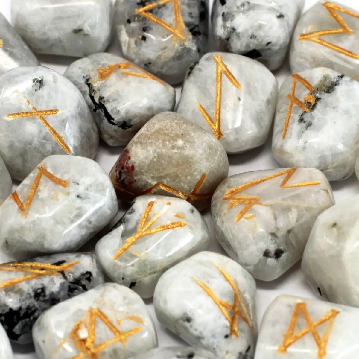 Rainbow moonstone rune stones marked with rune symbols and a pouch