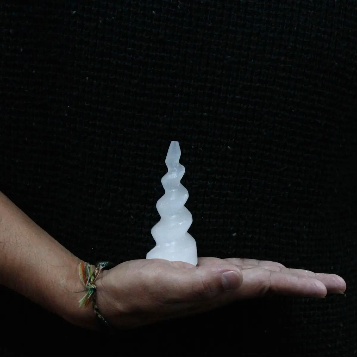 Milky white selenite tower with a spiral unicorn horn shape